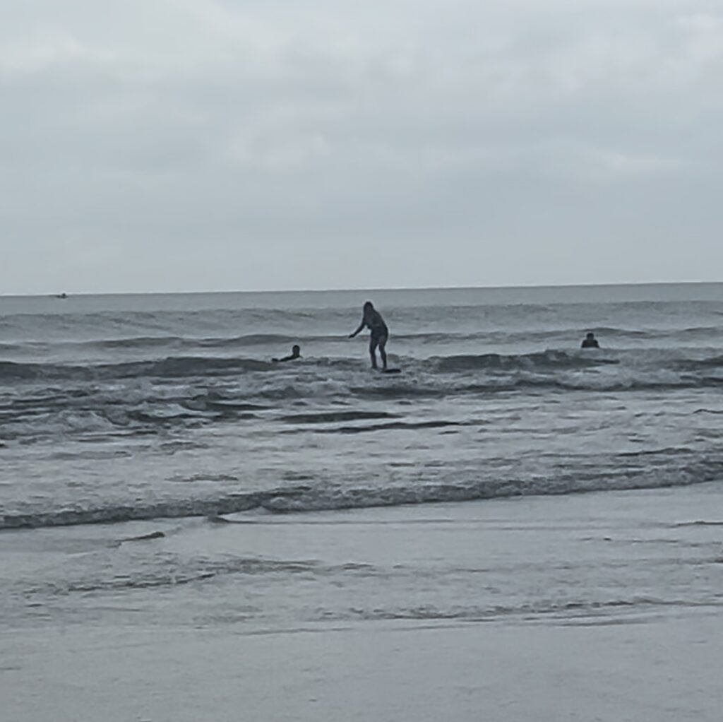 Me on a surf board as my mom takes the most novice picture